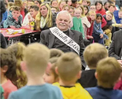  ?? H John Voorhees III/Hearst Connecticu­t Media ?? Monsignor Robert Weiss listens to preschoole­rs sing him a song during his retirement celebratio­n with students and staff at St. Rose of Lima parochial school. Weiss, the pastor of St. Rose of Lima Church in Newtown for the last 24 years, retired on Wednesday.