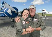  ?? GLENN JEFFREY/STUFF ?? Emeny gives his daughter Fay a hug after she performed a display at the Stratford Aero Club open day in
January 2021.