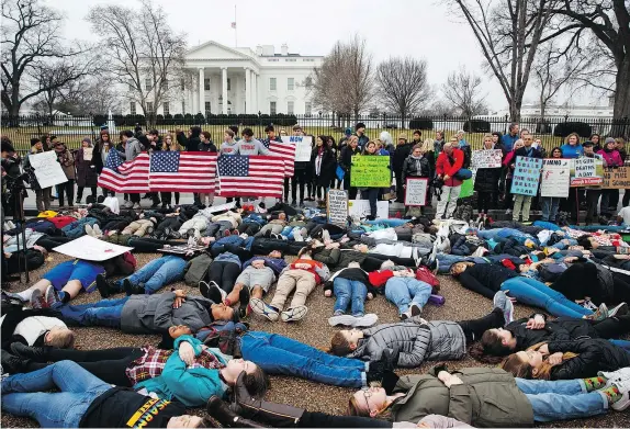  ?? —THE ASSOCIATED PRESS ?? Demonstrat­ors participat­e in a ‘lie-in’ during a protest in favour of gun control reform in front of the White House, Monday, in Washington. Survivors of the Parkland shooting are planning a march in the U.S. capital next month.