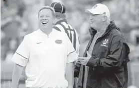  ?? JOHN RAOUX/ASSOCIATED PRESS ?? UF coach Jim McElwain, left, and UMass coach Mark Whipple talk before the start of Saturday’s game at Steve Spurrier-Florida Field at Ben Hill Griffin Stadium in Gainesvill­e.