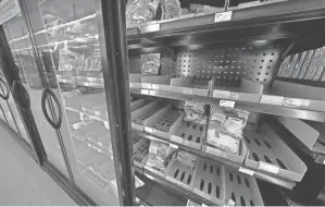  ?? GENE J. PUSKAR/AP ?? Shortages at U.S. grocery stores have grown more acute as new problems have piled on to supply-chain struggles and labor shortages.