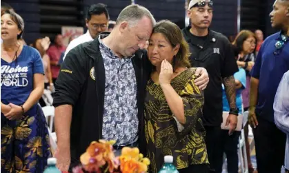  ?? Photograph: Kevin Lamarque/Reuters ?? Governor Josh Green embraces his wife Jaime Green at Lahaina Civic Center, Maui. The governor warned residents to ‘brace for’ higher casualty figures.