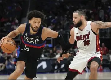  ?? PAUL SANCYA — THE ASSOCIATED PRESS ?? Detroit Pistons guard Cade Cunningham (2) drives on Miami Heat forward Caleb Martin (16) in the second half in Detroit on Friday.