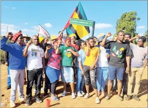  ?? (Pic: Thokozani Mamba) ?? Lomahasha youth leader Siboniso Mkhabela (2nd R) raising his fists together with the area’s youth members while some were carrying the signboard that was removed by the police.