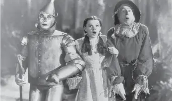  ?? FPG/Hulton Archive/Getty Images 1939 ?? The Tin Man, Dorothy and the Scarecrow in “The Wizard of Oz,” a movie that takes you home.