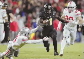  ?? AP PHOTO ?? RUNAWAY: Purdue running back D.J. Knox (c) cuts between Ohio State’s Jordan Fuller (l) and Pete Werner during Saturday’s upset win over the Buckeyes in West Lafayette, Ind.