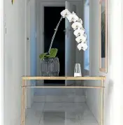  ??  ?? Modern and minimal are bywords in Anderson’s home. She counts this $49 brass side table as her favourite piece of furniture.