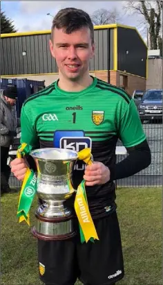  ??  ?? Donegal goalkeeper Luke White with the spoils of success.