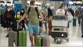  ?? MARTA LAVANDIER — THE ASSOCIATED PRESS ?? A family and their pets walk through Miami Internatio­nal Airport, Monday, in Miami.