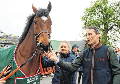  ?? HARRY MURPHY/SPORTSFILE ?? Jockey Davy Russell with Tiger Roll as the winner of the 2019 Randox Health Aintree Grand National is led through the village of Summerhill in Co Meath