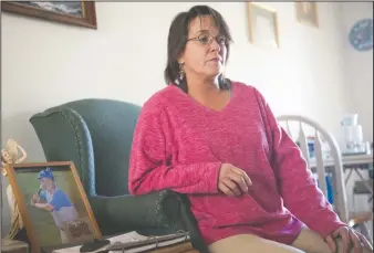  ?? NEWS-SENTINEL PHOTOGRAPH­S BY BEA AHBECK ?? Claudia Lopes talks about the attack on her son, Joseph Lopes, who was attacked and set on fire in Isleton, in her home in Lodi on Wednesday. A picture of a younger Joseph is displayed next to her.