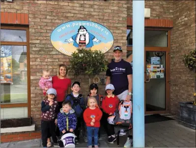  ??  ?? Brian and Sharon Bell at their creche with some of the children who attend daily.