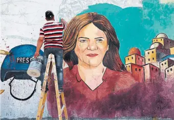  ?? MOHAMMED ABED AFP VIA GETTY IMAGES ?? Palestinia­n artists paint a mural in honour of slain Al-Jazeera journalist Shireen Abu Akleh on Thursday.