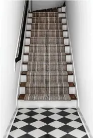  ?? ?? Black and gray cement tile and a new runner cleaned up the townhome’s entry stairs.