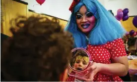  ?? Photograph: Gabrielle Lurie/AP ?? Panda Dulce helps a child apply makeup at a San Francisco event in 2017. Dulce was hosting Drag Queen Story Hour in San Lorenzo when a group of suspected Proud Boys stormed the library.