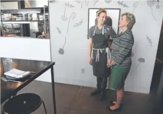  ?? Andy Cross, The Denver Post ?? Caroline Glover, left, owner of Annette restaurant, talks with Small Business Administra­tion Administra­tor Linda McMahon inside Glover’s restaurant at the Stanley Marketplac­e in Aurora on Thursday.