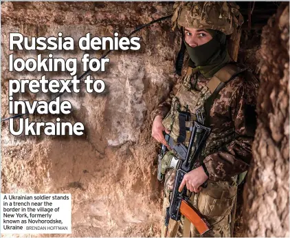  ?? BRENDAN HOFFMAN ?? A Ukrainian soldier stands in a trench near the border in the village of New York, formerly known as Novhorodsk­e, Ukraine