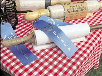  ?? BY JENNIFER CARTER CONTRIBUTE­D ?? Blue ribbons and rolling pins wait to be awarded to the prize winning bakers.