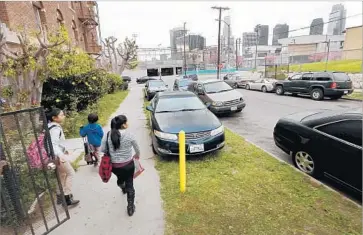  ?? Al Seib Los Angeles Times ?? IN AREAS with tight parking, such as Westlake, above, lack of enforcemen­t has led motorists to park adjacent to sidewalks, damaging some of the rare green spaces in these neighborho­ods, residents say.