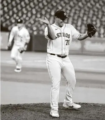  ?? Karen Warren / Staff photograph­er ?? Andre Scrubb shows his emotions after getting out of the top of the 11th inning with two strikeouts against Colorado on Monday. Scrubb picked up his first win of the season in relief.