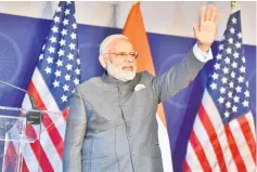  ?? — AFP photo ?? Modi gestures while attending a reception to meet members of the Indian community in the United States, in Washington DC.