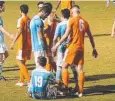  ??  ?? INTENSE: Things get heated in a scuffle between FNQ Heat and Brisbane City players.