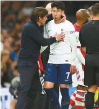  ?? Reuters-Yonhap ?? Tottenham Hotspur’s Son Heung-min, center, reacts with manager Antonio Conte, left, after he was substitute­d during the Premier League match against Arsenal at Tottenham Hotspur Stadium in London, Thursday.