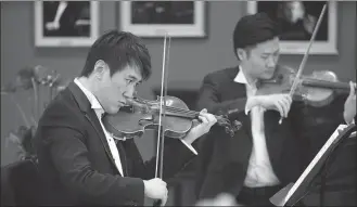  ?? PHOTOS PROVIDED TO CHINA DAILY ?? Top: A quintet from the NCPA Orchestra perform a piece by Ludwig van Beethoven for the opening of its Spring Online Concerts series on April 11. Above: Two violinists from the NCPA Orchestra’s string quartet, Li Zhe (left) and Liu Xian, perform during the event.