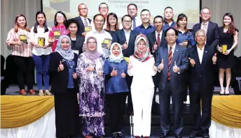  ?? — Photo by Chimon Upon ?? Fatimah (front, fourth left), flanked by Harden and Rosey, joins Ting (front, right) and representa­tives of KGC partners in a group photo. Also seen on the front row are (from left) Noriah and Dr Saadiah.