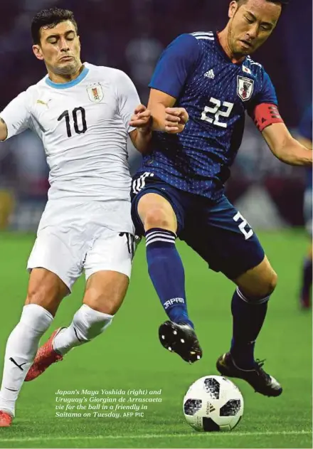  ?? AFP PIC ?? Japan’s Maya Yoshida (right) and Uruguay’s Giorgian de Arrascaeta vie for the ball in a friendly in Saitama on Tuesday.