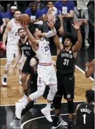  ?? FRANK FRANKLIN II — THE ASSOCIATED PRESS ?? The Philadelph­ia 76ers’ Ben Simmons (25) shoots over Brooklyn Nets’ Jarrett Allen (31) during the first half in Game 3 of a first-round NBA basketball playoff series Thursday in New York.