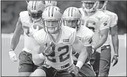  ?? AP/CHUCK BURTON ?? Carolina Panthers running back Christian McCaffrey (22) is drawing rave reviews about his athleticis­m from veteran players and coaches during his first week of training camp.