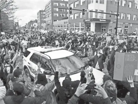  ?? KYLE ROBERTSON/COLUMBUS DISPATCH ?? Angry Ohio State students protest against the Columbus police in April after the police shooting that killed Ma'khia Bryant. Protesters marched to the Statehouse and called on Ohio State, among other things, to sever its mutual aid agreement with city police.