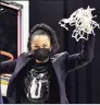  ?? Elsa / Getty Images ?? South Carolina coach Dawn Staley cuts down the net after beating Texas to advance to the Final Four on Tuesday night in San Antonio.