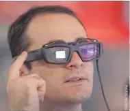  ??  ?? A visitor uses a touch bar to scroll through a menu on Vuzix Blade Augmented Reality Smart Glasses at the 2018 Consumer Electronic­s Show in Las Vegas.