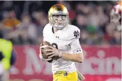  ?? MARK J. TERRILL/ASSOCIATED PRESS ?? Quarterbac­k Ian Book and Notre Dame went undefeated and claimed the No. 3 seed in the college football tournament.