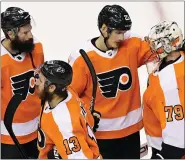  ?? FRANK GUNN — THE CANADIAN PRESS ?? Philadelph­ia Flyers left wing Oskar Lindblom (23) consoles Flyers goaltender Carter Hart (79) after their defeat by the New York Islanders in NHL Stanley Cup Eastern Conference playoff hockey game action in Toronto, Saturday.