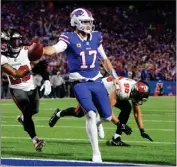  ?? TIMOTHY T LUDWIG — GETTY IMAGES ?? Bills quarterbac­k Josh Allen runs for a touchdown against the Buccaneers during the second quarter Thursday night.