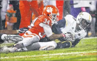  ?? JOHN BAZEMORE / ASSOCIATED PRESS ?? Defensive back Step Durham battles Clemson receiver Ray-Ray McCloud for a loose ball last week. Despite hopeful signs, Tech’s defense does not rank high statistica­lly.