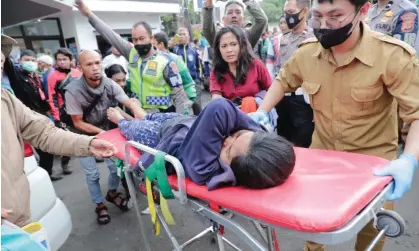  ?? Photograph: Adi Weda/EPA ?? Rescuers carry an injured victim of the earthquake at a hospital in Cianjur, Indonesia.