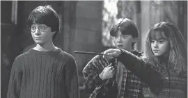  ?? WARNER BROS. PICTURES ?? New Hogwarts students Harry Potter ( Daniel Radcliffe), from left, Ron Weasley ( Rupert Grint) and Hermione Grainger ( Emma Watson) appear in a scene from “Harry Potter and the Sorcerer’s Stone.”