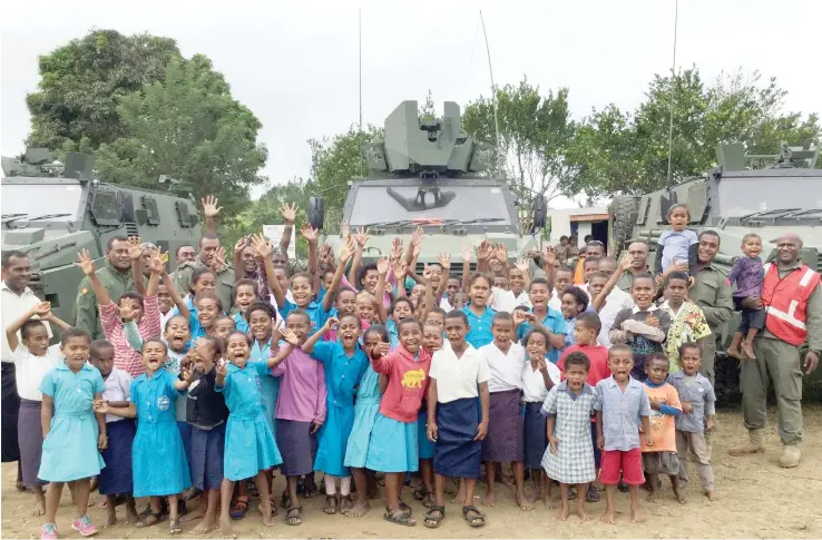  ?? Photo: RFMF Directorat­e of Peace Support Operations ?? The Bushmaster vehicles with school children from Nausori Village and soldiers.