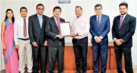  ?? ?? Secretary to the Ministry of Environmen­t and Chairman of Sri Lanka Climate Fund Dr Anil Jasinghe (4th from left) presents the Carbon Neutral certificat­e to BoardPAC Chairman Vijendran Watson in the presence of (from left) Ms. Harshani Abeyrathna, Verificati­on Manager SLCF; Chamara Ariyathila­ka, CEO SLCF; Buddhika Abeygooner­atne, Head of Operations & Systems BoardPAC; Rajitha Kuruppumul­le, Chief Operating Officer BoardPAC and Thusitha Jayanath, Operations Manager BoardPAC.