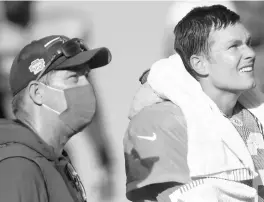  ?? DIRK SHADD/TAMPA BAY TIMES ?? Buccaneers general manager Jason Licht, left, talks with quarterbac­k Tom Brady during training camp in September at Raymond James Stadium.