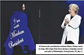  ??  ?? US Democratic presidenti­al nominee Hillary Clinton reacts on stage with singer Katy Perry during a campaign concert and rally in Philadelph­ia, Pennsylvan­ia, US, Nov. 5.