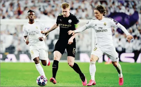  ?? AFP ?? Manchester City’s Belgian midfielder Kevin De Bruyne (centre) vies with Real Madrid’s Croatian midfielder Luka Modric (right) during their Champions League on February 26, 2020.