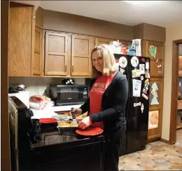  ?? Donnis Hueftle-Bullock ?? Above, Heidi Fessler serves an evening meal, one of the make-ahead meals she prepares so family meal time is quick and easy.