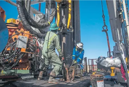  ?? New York Times file ?? Employees work on a drilling rig contracted to Shell in the Delaware Basin, near Wink, Texas, in January 2019. Energy companies are dealing with low demand because of the coronaviru­s pandemic and low prices because of a dispute between Russia and Saudi Arabia.