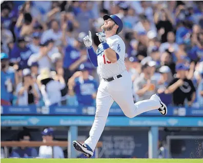  ?? JAE C. HONG/ASSOCIATED PRESS ?? Max Muncy celebrates his two-run home run in the fifth inning of the Dodgers’ win over the Rockies Tuesday in a tiebreaker game that gave the Dodgers’ their sixth straight NL West title.