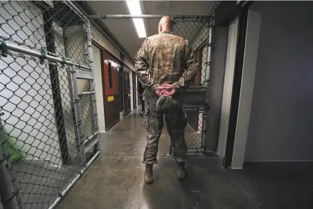  ?? Doug Mills / New York Times 2019 ?? A member of the military stands at the Camp 5 detention center during a media tour at Guantanamo Bay, Cuba, in April 2019.